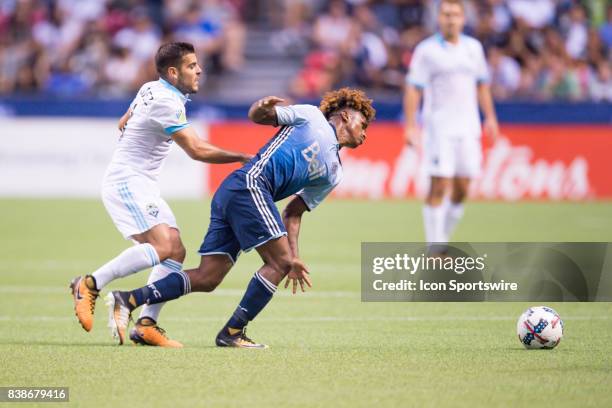 Vancouver Whitecaps forward Yordi Reyna is tripped up by Seattle Sounders midfielder Alvaro Fernandez during their match at BC Place on August 23,...