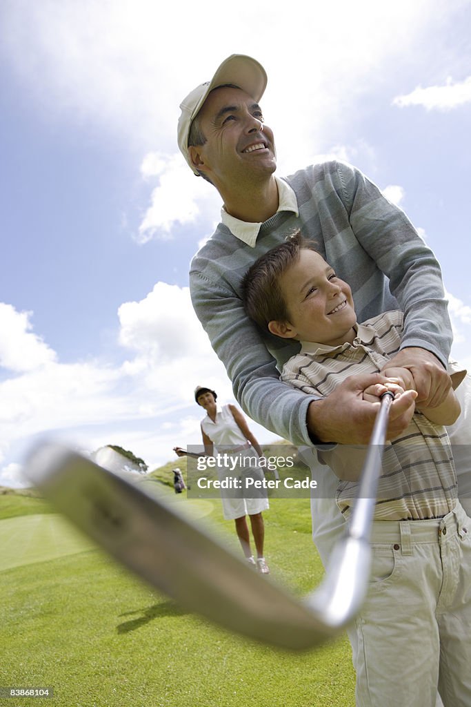 Family playing golf