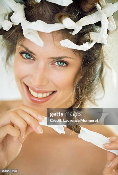 smiling woman with blue eyes wearing curlpaper - hair curlers stock pictures, royalty-free photos & images