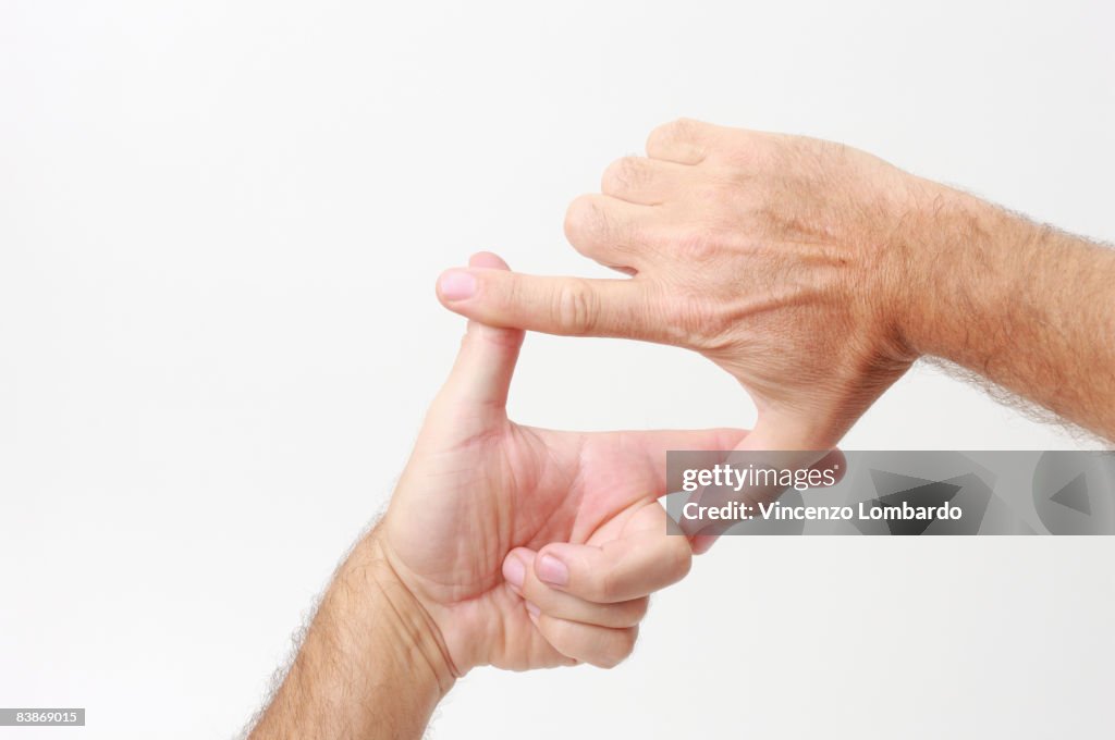 Man making a finger frame  on White Background.