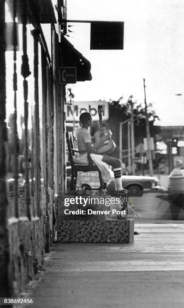 Kenny says he averages five to six shines a day at shoeshine stand. Credit: Denver Post