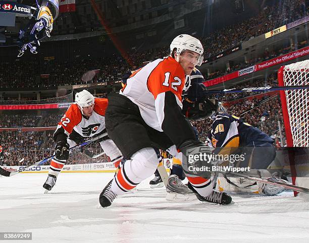 Simon Gagne of the Philadelphia Flyers reaches for the puck against the Buffalo Sabres on November 21, 2008 at HSBC Arena in Buffalo, New York.