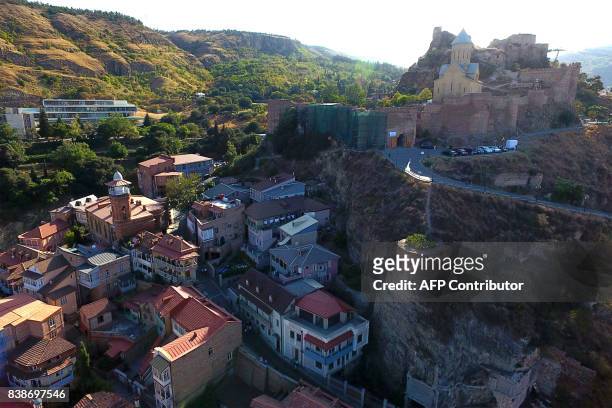 Picture taken with a drone on August 23, 2017 shows a view of the Georgian capital of Tbilisi. / AFP PHOTO / Vano SHLAMOV