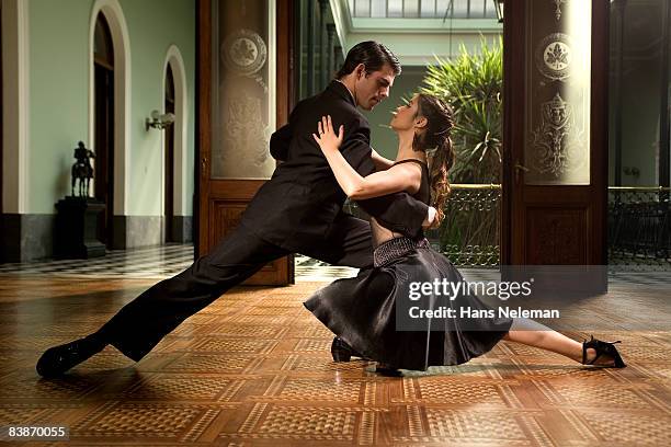 young couple tango dancing  - ballroom dancing stock pictures, royalty-free photos & images