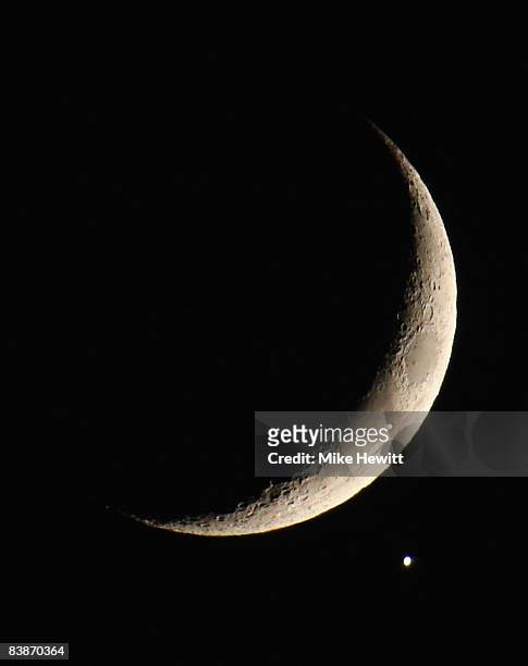 The planet Venus appears close to the crescent Moon as during a rare planetary alignment on December 1, 2008 in Brighton, England.