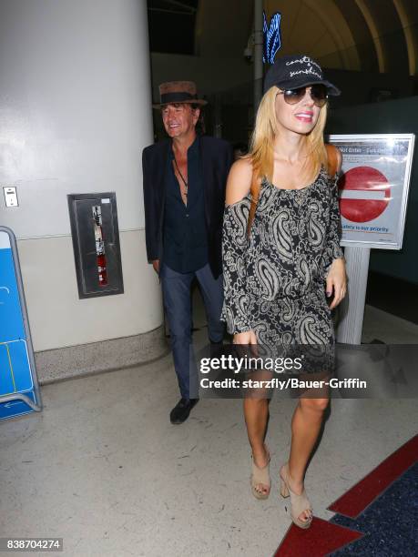 Richie Sambora and Orianthi Panagaris are seen at Los Angeles International Airport on August 24, 2017 in Los Angeles, California.