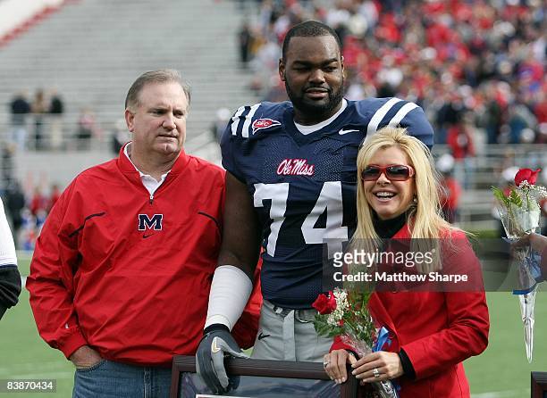 Michael Oher of the Ole Miss Rebels stands with his family during senior ceremonies prior to a game against the Mississippi State Bulldogs at...