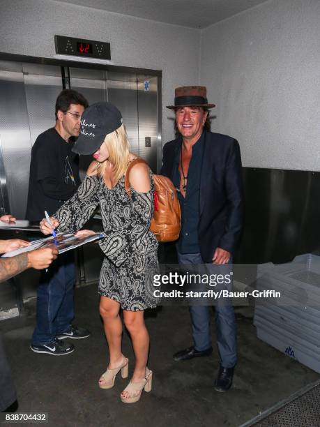 Richie Sambora and Orianthi Panagaris are seen at Los Angeles International Airport on August 24, 2017 in Los Angeles, California.