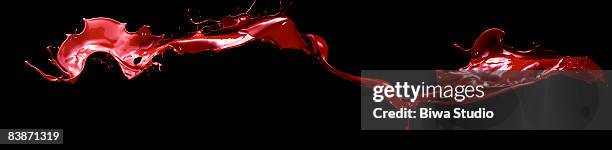 flying red ink on black back - red liquid stock pictures, royalty-free photos & images