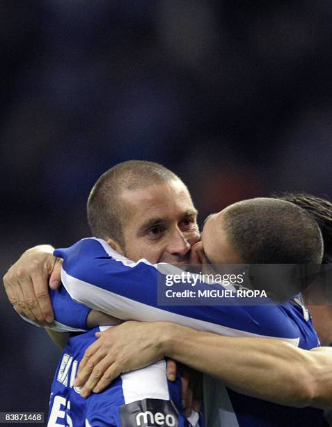 Porto's player Raul Meireles is kissed by teammate Argentinian Lisandro Lopez after scoring the second goal against Academica during their Portuguese...