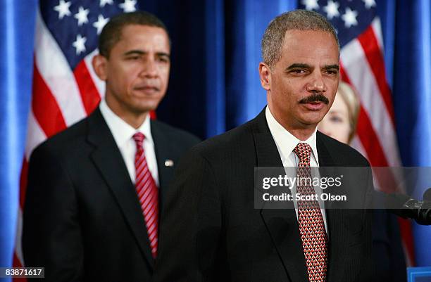 President-elect Barack Obama listens to attorney general-select Eric Holder at a press conference at the Hilton Hotel December 01, 2008 in Chicago,...