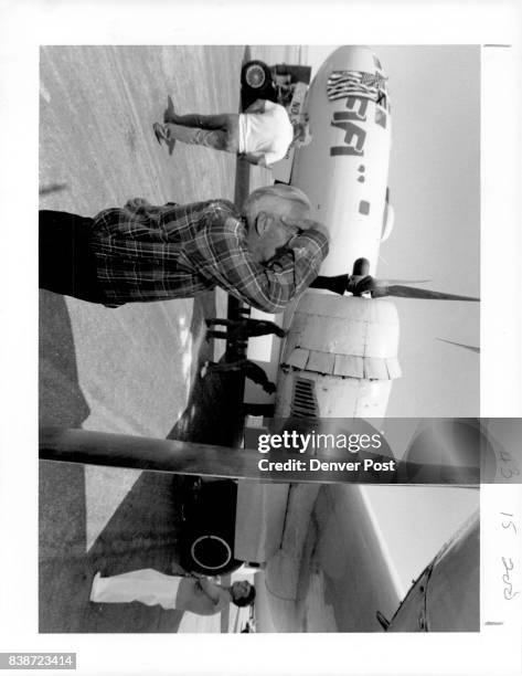 Bob Legge, Aurora, studies the engine on the B-29 Superfortress bomber on display. Credit: The Denver Post
