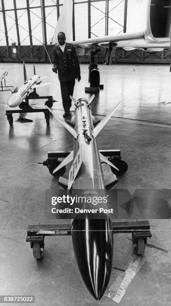 Chief M. Sgt. LeRoy Jefferson explains AIM-7 "Sparrow," air-to-air missile at left, and the AGM-45 "Shrite" air-to-ground missile. "Sparrow" is...