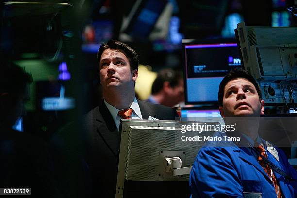 Traders work on the floor of the New York Stock Exchange moments before the closing bell December 1, 2008 in New York City. The Dow closed down...