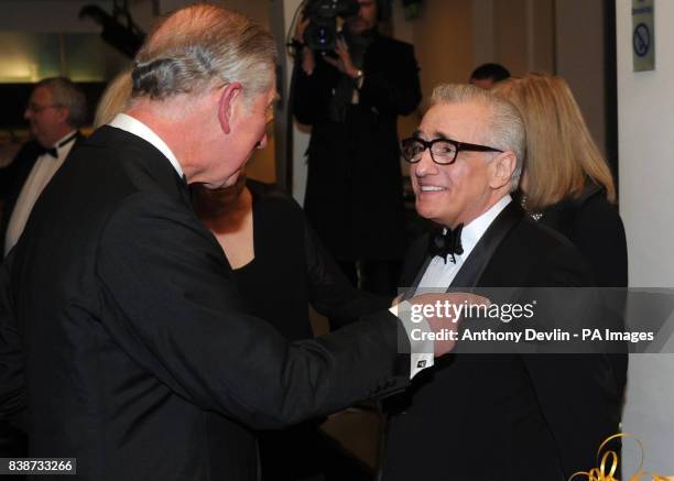 The Prince of Wales meets Martin Scorsese as he and the Duchess of Cornwall attend the Royal Film Performance 2011 of Hugo at the Odeon Cinema in...