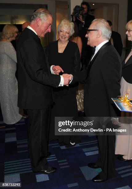 The Prince of Wales meets Martin Scorsese as he and the Duchess of Cornwall attend the Royal Film Performance 2011 of Hugo at the Odeon Cinema in...