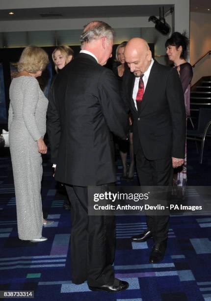 The Prince of Wales meets Sir Ben Kingsley as he and the Duchess of Cornwall attend the Royal Film Performance 2011 of Hugo at the Odeon Cinema in...