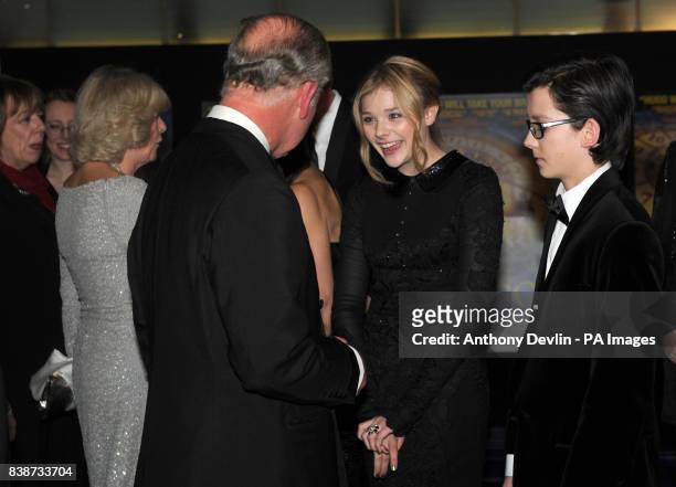 The Prince of Wales meets Chloe Moretz and the Duchess of Cornwall meets Helen McCroy as they attend the Royal Film Performance 2011 of Hugo at the...