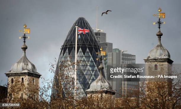 The Swiss Re building, also known as the Gherkin, and the Tower of London, are seen from Tower Bridge in London.