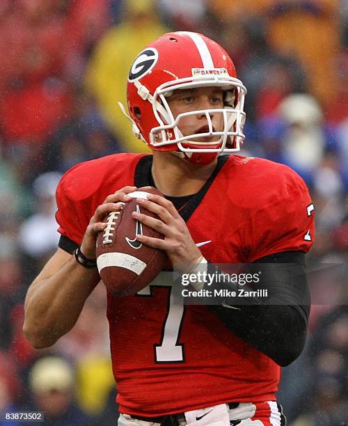 Quarterback Matthew Stafford of the Georgia Bulldogs drops back to pass during the game against the Georgia Tech Yellow Jackets at Sanford Stadium on...
