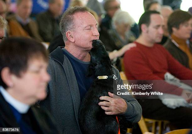 Michael Steingraber , who is HIV positive, is kissed by his dog Koko during a prayer at a World AIDS Day ceremony at the National AIDS Memorial Grove...