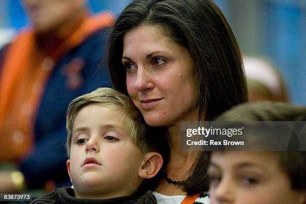 Kathleen Swinney, wife of new head coach Dabo Swinney of the Clemson Tigers, hold there son Clay during a press conference at Memorial Stadium on...