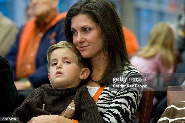 Kathleen Swinney, wife of new head coach Dabo Swinney of the Clemson Tigers, hold there son Clay during a press conference at Memorial Stadium on...