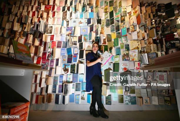 Rachel Taylor in front of a wall of books on display at the pop-up 15,000-book library in Selfridges department store, London.