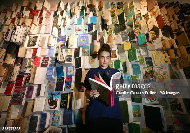 Rachel Taylor in front of a wall of books on display at the pop-up 15,000-book library in Selfridges department store, London.