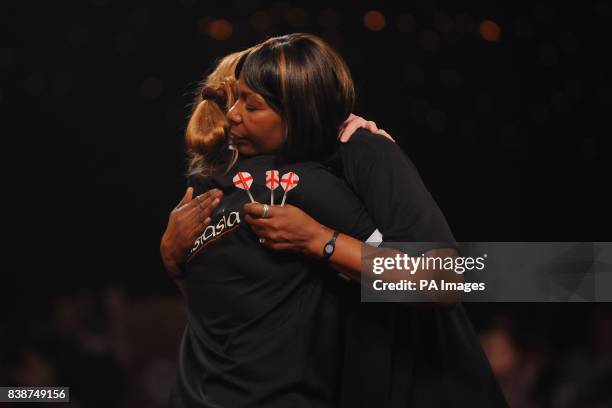 Russia's Anastasia Dobromyslova and England's Deta Hedman embrace after the final of the Women's BDO World Professional Darts Championships, which...