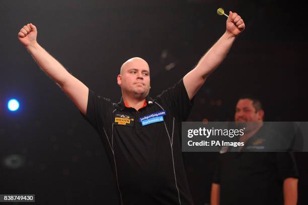 Netherland's Christian Kist celebrates victory over England's Alan Norris in the quarter finals of the BDO World Professional Darts Championships at...