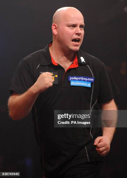 Netherland's Christian Kist celebrates victory over England's Alan Norris in the quarter finals of the BDO World Professional Darts Championships at...