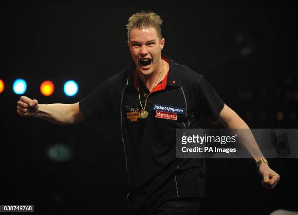 Netherland's Wesley Harms celebrates winning the fourth set in the Quarter Final during the BDO World Professional Darts Championships at the...