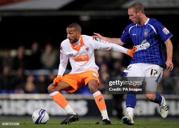 Blackpool's Elliott Grandin holds off Ipswich Town's Andy Drury during the npower Championship match at Portman Road, Ipswich.