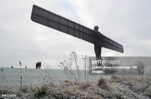 Frost covers the ground as people take a walk near the Angel of the North, Newcastle, as forecasters expect the cold weather to last until the middle...