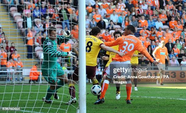 Arsenal goalkeeper Jens Lehmann dives to save a shot from Blackpool's Dudley Campbell