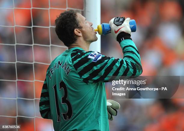 Arsenal goalkeeper Jens Lehmann takes a drink during the game