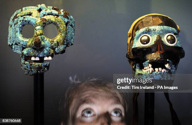 Person views a Mosaic Skull of Tezcatlipoca made with a real human skull and a Mask of Tlaloc , at the press viewing of the British Museum's new...