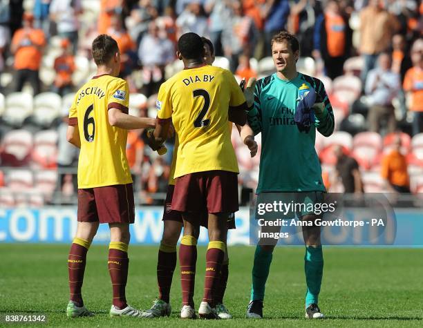 Arsenal goalkeeper Jens Lehmann celebrates victory with teammates after the final whistle