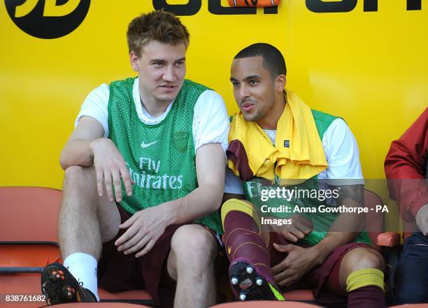 Arsenal's Theo Walcott and Nicklas Bendtner on the bench