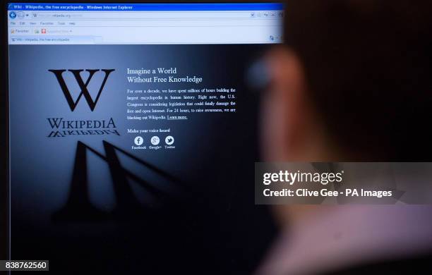 An office worker is greeted by a blacked out Wikipedia page as they attempt to access the site.