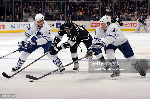 Andre Deveaux and Jeff Finger of the Toronto Maple Leafs defend against Anze Kopitar of the Los Angeles Kings during the game on December 1, 2008 at...