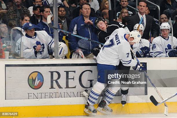 Ian White of the Toronto Maple Leafs checks Oscar Moller of the Los Angeles Kings into the boards during the game on December 1, 2008 at Staples...