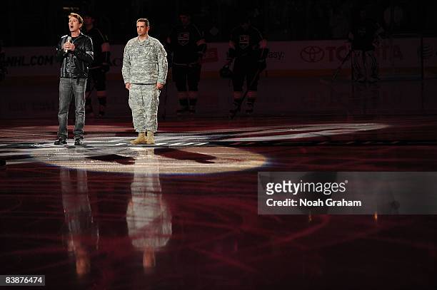 Singer Davis Gaines sings the National Anthem with military hero U.S. Army Sergeant First Class Douglas Dietal prior to the game between the Toronto...