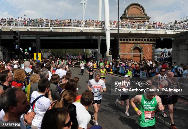 Competitors run along the Embankment during the 31st Virgin London Marathon in London.