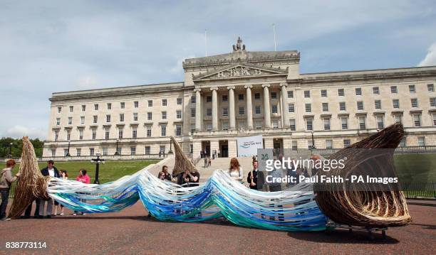 Schoolchildren arrive at Stormont with a life size basking shark made from willow and ribbon which they presented to Environment Minister Alex...