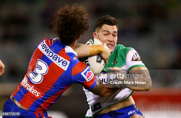 Nikola Cotric of the Raiders is tackled during the round 25 NRL match between the Canberra Raiders and the Newcastle Knights at GIO Stadium on August...