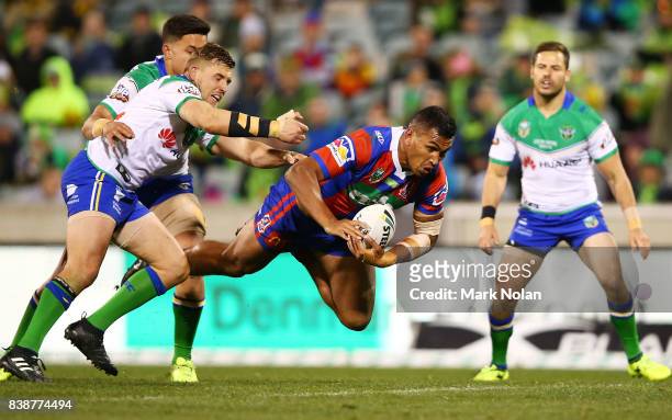 Jacob Saifiti of the Knights is tackled during the round 25 NRL match between the Canberra Raiders and the Newcastle Knights at GIO Stadium on August...