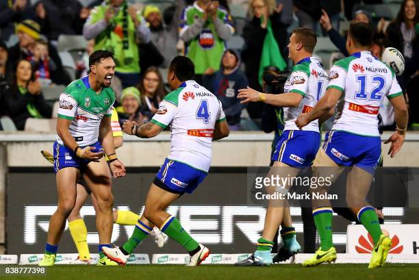 Jordan Rapana of the Raiders celebrates a try with team mates during the round 25 NRL match between the Canberra Raiders and the Newcastle Knights at...