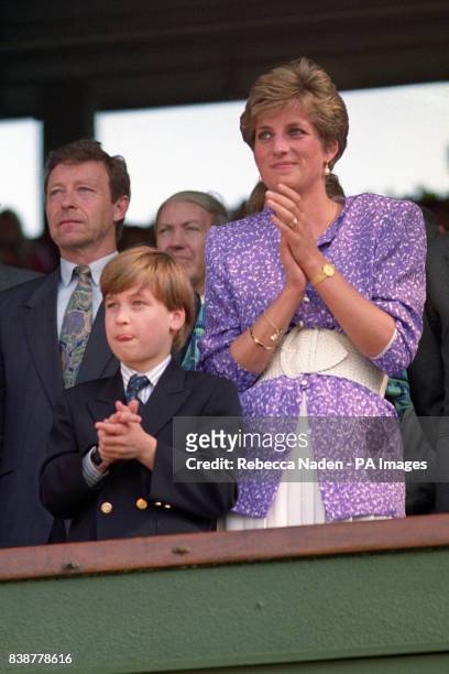 Diana, Princess of Wales and Prince William stand and applaud in the Royal Box on Centre Court at Wimbledon, as Steffi Graf wins the Women's Singles...